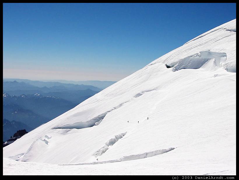 Climb of Mount Rainier: party of three on the high traverse below the bergschrund Climb of Mount Rainier: party of three on the high traverse below the bergschrund