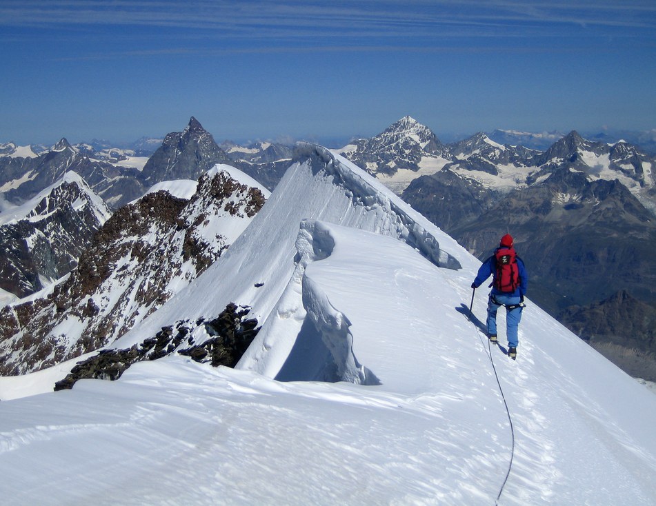 Lyskamm ridge traverse and Castor: Rainer on the ridge traverse from Lyskamm East to Lyskamm West summit with big cornice; in the background from left to right: Dent d'Herens, Matterhorn, Dent Blanche, Grand Cornier, and Obergabelhorn Lyskamm ridge traverse and Castor: Rainer on the ridge traverse from Lyskamm East to Lyskamm West summit with big cornice; in the background from left to right: Dent d'Herens, Matterhorn, Dent Blanche, Grand Cornier, and Obergabelhorn