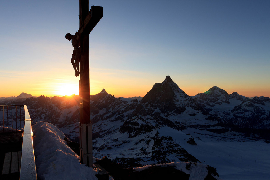 On the summit of Klein Matterhorn during sunset. (keywords: alpen, alps, berg, berge, dent d'hérens, grand combin, matterhorn, schweiz, sonnenuntergang, switzerland, valais, wallis, cross, mountain, mountains, sunset, swiss, dent d'hrens) On the summit of Klein Matterhorn during sunset. (keywords: alpen, alps, berg, berge, dent d'hérens, grand combin, matterhorn, schweiz, sonnenuntergang, switzerland, valais, wallis, cross, mountain, mountains, sunset, swiss, dent d'hrens)